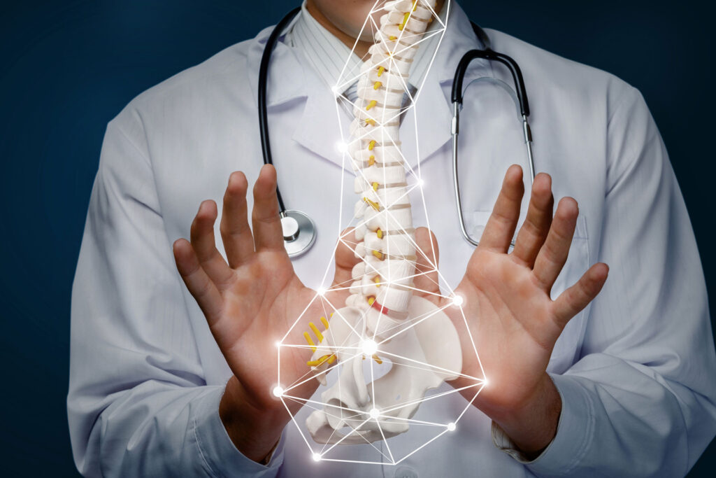 digital rendition of the spine in front of a doctor