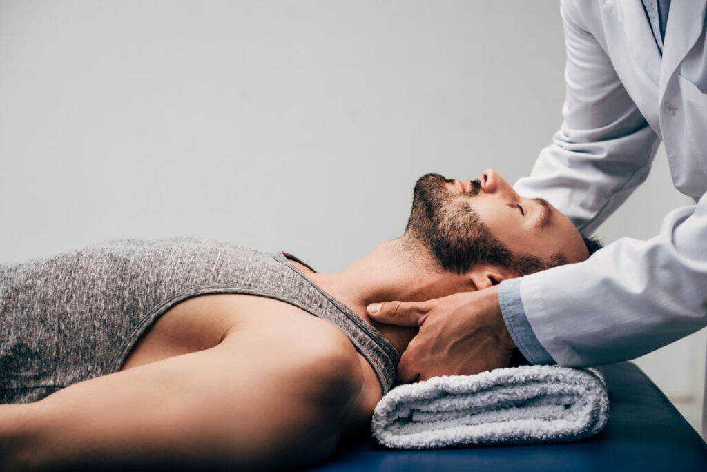 man receiving chiropractic massage on table