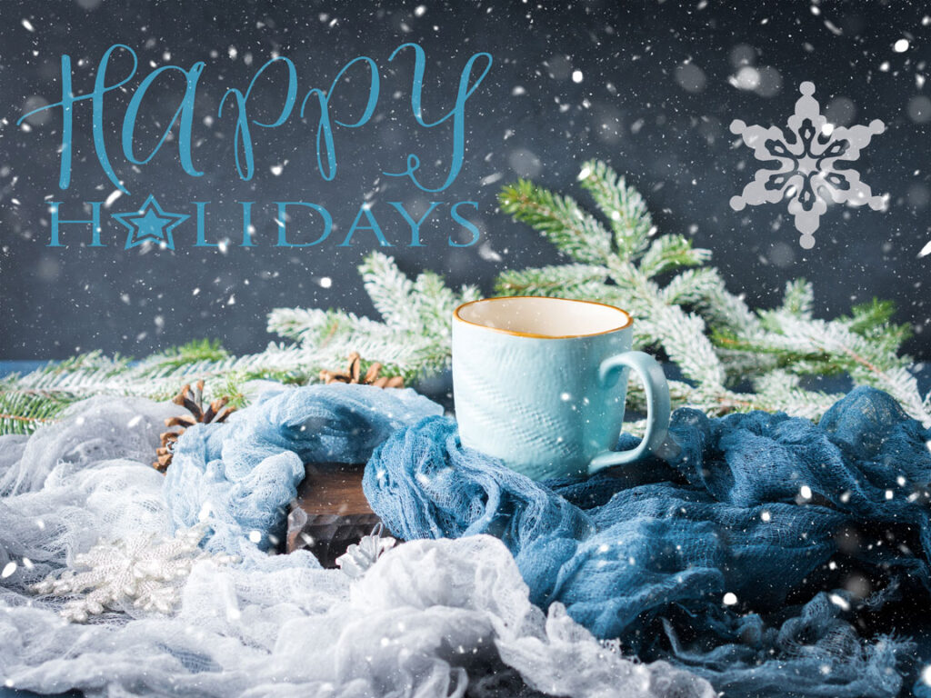 Happy holidays message with snow and a coffee mug