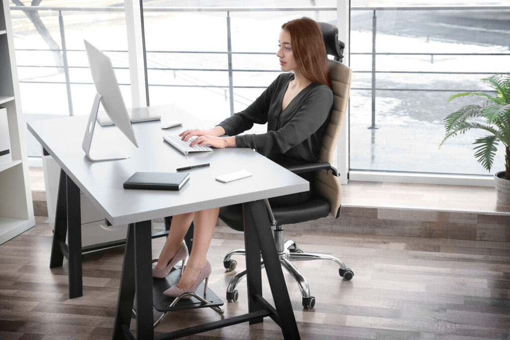 woman practicing good posture while sitting at desk