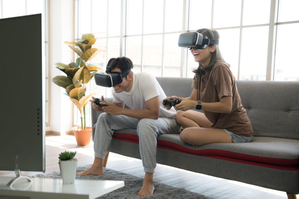 couple playing virtual reality eSports on couch