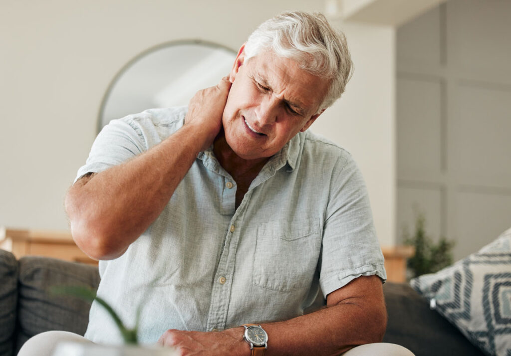 senior male experiencing neck pain