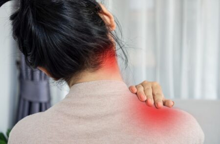 red marks indicating pain in a woman's back and neck