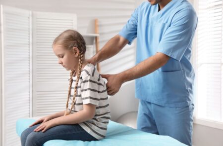 little girl with blonde hair at a chiropractic appointment