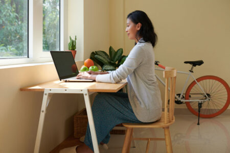 woman practicing good posture at her desktop computer