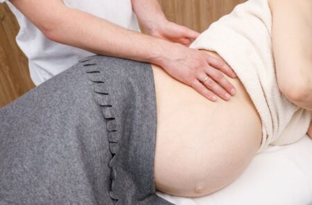 pregnant woman getting chiropractic therapy