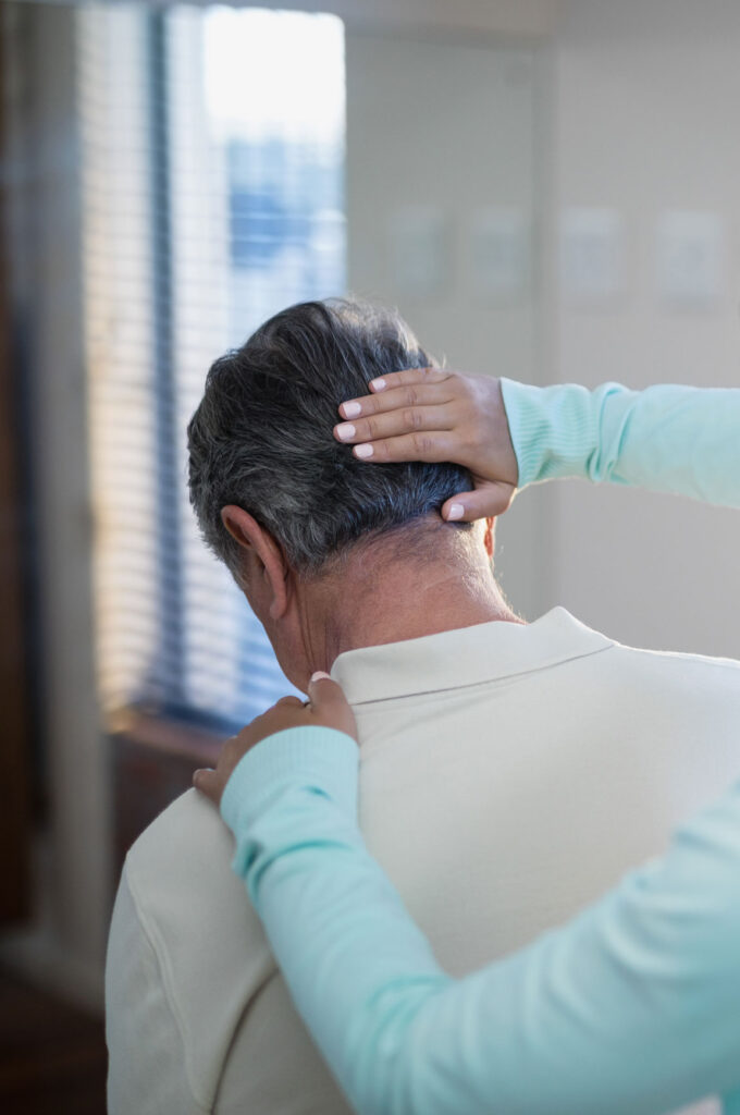 chiropractor's hands relieving neck pain