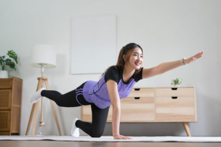 young Asian woman doing bird dog exercise