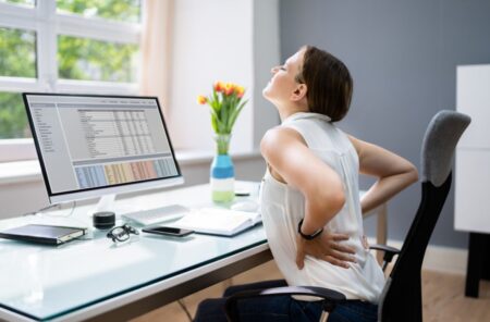 woman with back pain while working