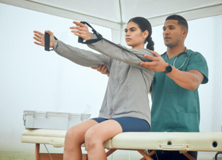 cropped-shot-of-a-handsome-young-male-physiotherap-2023-11-27-05-09-12-utc Doctor helping patient