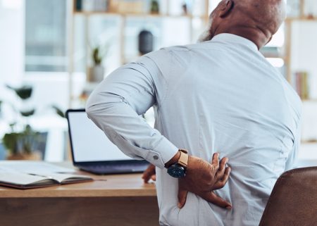 back-pain-and-business-stress-of-black-man-with-m-2023-11-27-04-55-34-utc Man holding back in pain