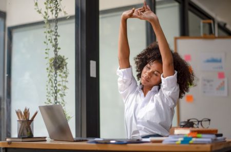 woman stretching in office after chiropractic adjustment
